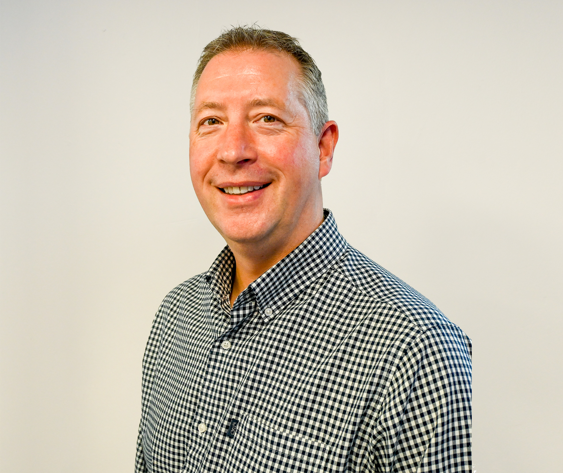 Rob standing smiling with shirt on.