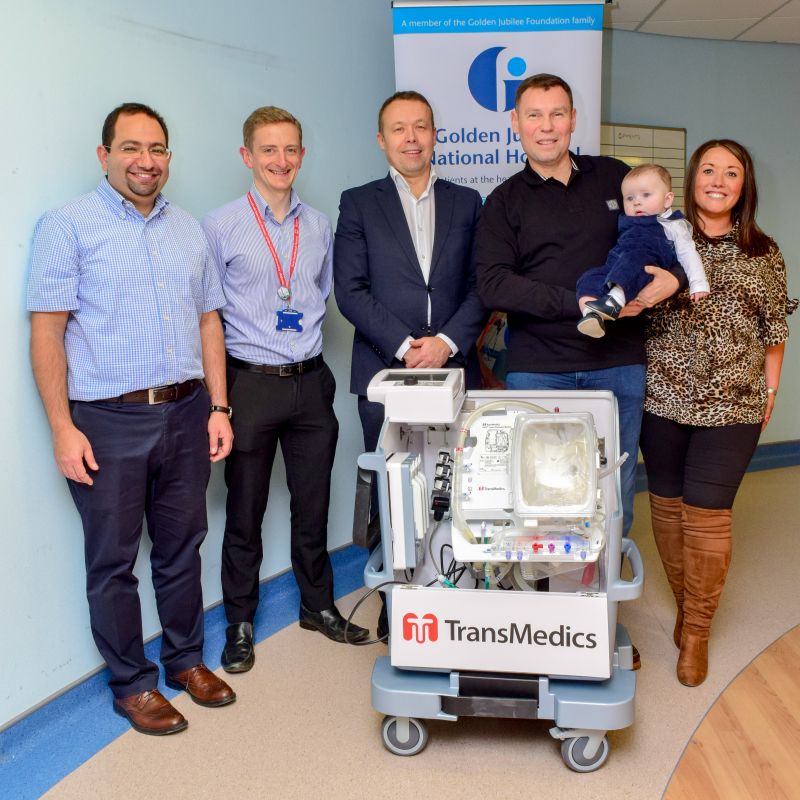 staff with Roger Marr, wife Caroline, baby son Rocco and the OCS machine