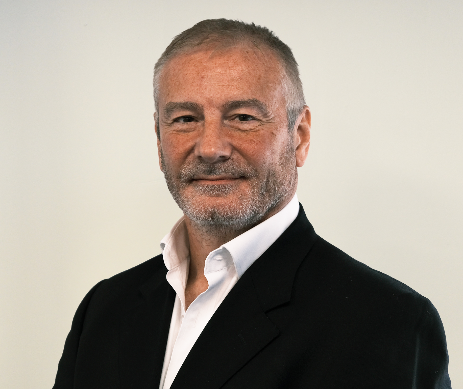 Headshot of Lindsay smiling with black blazer and white shirt.