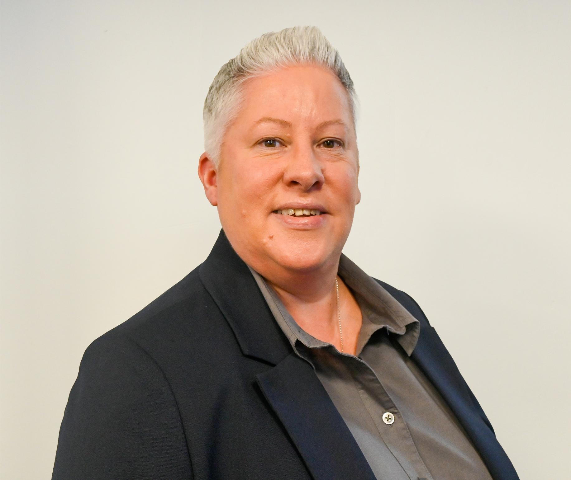 Headshot of Carole Anderson smiling and wearing striped shirt.